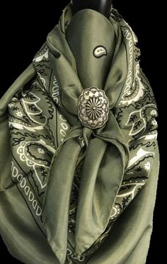 a green scarf with an ornate design on it