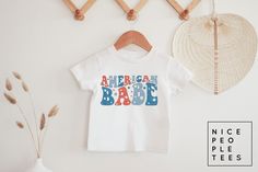 Toddler American Babe Shirt, Kids Fourth of July Shirt, Toddler 4th of July tee, kids USA shirt, Baby Fourth of July shirt, Infant bodysuit BABY & KIDS SHIRTS & BODYSUITS Depending on availability we alternate between the brands Bella + Canvas and Rabbit Skins bodysuits/tees, both have the same fit and are premium quality ► BODYSUIT DETAILS - 5 oz., 100% combed ringspun cotton - 1x1 baby rib - Flatlock stitched seams - Innovative three-snap closure - Double-needle stitched ribbed binding - Easy Playful T-shirt For 4th Of July With Crew Neck, Playful Crew Neck T-shirt For 4th Of July, Playful White T-shirt For 4th Of July, Cute Cotton T-shirt For 4th Of July, Cute 4th Of July Birthday T-shirt, Playful Cotton T-shirt For Gender Reveal, Unisex Name Print Shirt For Summer, 4th Of July Short Sleeve Tops With Name Print, Cute Short Sleeve Shirt For 4th Of July