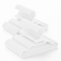 three pieces of white plastic on a white surface