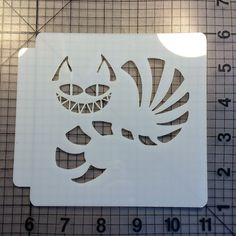 a cutout of a cat with sharp teeth on it's face and tail