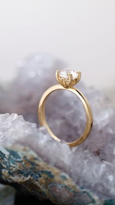 a gold ring sitting on top of a rock