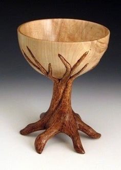 a wooden bowl that has been carved to look like a tree