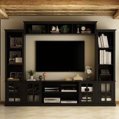 an entertainment center with bookshelves and a flat screen tv mounted on the wall