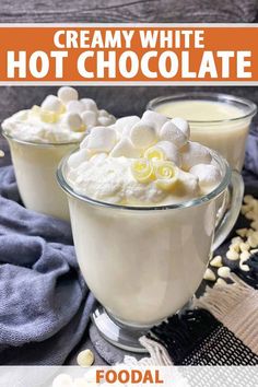 creamy white hot chocolate in a glass mug with marshmallows on top