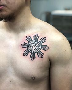 a man with a tattoo on his chest