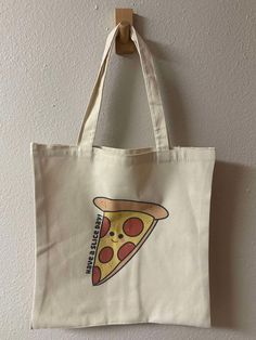 Have A Slice Day Tote Bag | Market Totebag , Food Totebag , Reusable Totebag , Cute Totebag , Shopping Totebags, Canvas Totebag WHAT IS INCLUDED? - Have A Slice Day Tote Bag DETAILS "Have A Slice Day" Tote Bag - your perfect companion for a cheerful and eco-friendly lifestyle! This spacious and durable tote features a fun, pizza-inspired design that brightens up your day. Ideal for shopping, beach trips, or everyday use. Carry your essentials with a slice of joy and spread positivity wherever you go with the "Have A Slice Day" Tote Bag! -Print on One side -100% Polyester  PLEASE NOTE -Dimensions: 15"x16"  -There is no refund on our products. Please message me if you have any concerns with your item.  SHIPPING: Orders will be shipped 1-3 Business Days  FOR MORE LISTINGS, PLEASE CHECK OUT: h White Canvas Grocery Bags, Reusable Tote Lunch Bag For Daily Use, Large Everyday Reusable Bag, Large Everyday Reusable Bags, Reusable Canvas School Bag, Rectangular Reusable Canvas Bag For School, Rectangular Reusable School Bag, Eco-friendly Recyclable School Bags, Reusable Tote Bag For Grocery