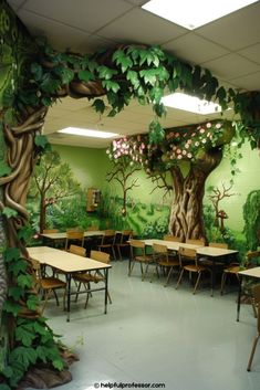 an empty classroom with desks and chairs in front of a tree painted on the wall