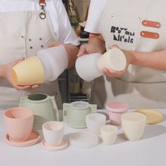 two people are making cups with their hands