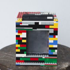 a small toy made out of legos sitting on top of a wooden table