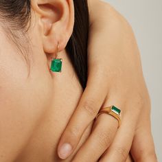 Charm your way through life with the Endless Emerald Earring, a sublime selection from our Envy collection. Made from top-tier 925 sterling silver and plated with shimmering 14K gold, this enviable design exudes endless possibilities. The baguette cut emerald fusion stone is set in a matching 14K gold bordered base for a smooth style and glamorous addition to your ensembles. Metal: 925 Silver Plating: 14K Gold E-coated Diameter: 0.3" Stone: Emerald Fusion Stone Faceted Green Emerald Ring, Faceted Emerald Ring In Sterling Silver, Formal Baguette-cut Emerald Earrings, Modern Green Emerald-cut Jewelry, Elegant Faceted Emerald Gemstones, Baguette Ring, Gold Border, Baguette Cut, Emerald Earrings