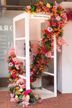 a display case with flowers on the outside