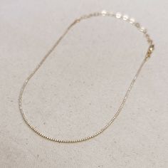 Adorn your neck with this stunning 18k Gold-filled Tennis necklace. Delicate and minimalist, its classic look is sure to make a statement. Our 1.2mm Cubic Zirconia stones shine brightly, making this the perfect accessory for any outfit. Metal: 18k Gold Filled High-quality AAAAA Cubic Zirconia Material: 1.2mm micro CZ chain Size: 12 inches long + 4 inches extender chain Hypoallergenic Water-resistant Handcrafted in Brazil Also available our matching Tennis Bracelet to complete your outfit. Dainty Cubic Zirconia Diamond Necklace With Delicate Chain, Minimalist Diamond Tennis Necklace As Gift, Dainty Necklace With Delicate Chain And Cubic Zirconia, Dainty Cubic Zirconia Chain Necklace With Delicate Chain, Dainty Cubic Zirconia Delicate Chain Necklace, Gold Delicate Chain Necklace With Cubic Zirconia, Dainty Round Tennis Necklace Gift, Dainty Round Tennis Necklace As Gift, Dainty Tennis Necklace For Gift