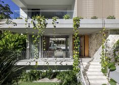 the house is surrounded by greenery and plants