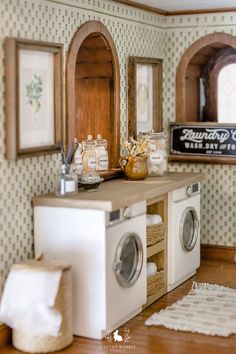 a laundry room with washer, dryer and mirror on the wall next to it