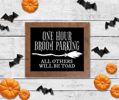 a sign that says one hour broom parking all others will be toad with bats around it