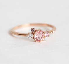 https://www.capucinne.com/products/peach-sapphire-engagement-gold-ring-cluster-sapphire-diamond-engagement-ring-8472?_pos=89&_sid=186a64c1c&_ss=r Peach Sapphire Engagement Ring Rose Gold, Peach Sapphire Rings, Peach Sapphire Engagement Ring, Diamond Sapphire Engagement Ring, Sapphire Diamond Engagement, Gold Sapphire Ring, Peach Sapphire, Diamond Cluster Engagement Ring, Modern Engagement Rings