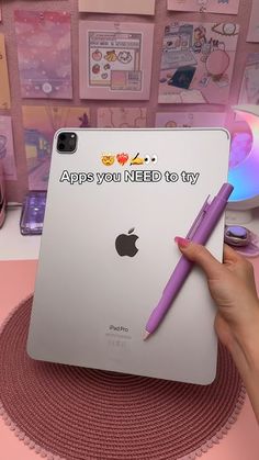 a person holding an ipad with a sticker on it and writing apps you need to try