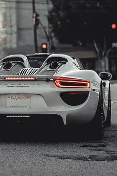 a white sports car is parked on the street