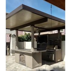 an outdoor kitchen with grill and sink