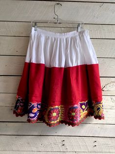 "Mexican red wool skirt with embroidered floral design White cotton blend Size Waist - 36\" Length - 23\" Condition - very good vintage" Fitted Folk Style Skirt, Traditional Embroidered Mini Skirt, Traditional Embroidered Skirt For Spring, Traditional Embroidered Spring Skirt, Traditional Red Bottoms For Spring, Vintage Embroidered Skirt For Spring, Fitted Embroidered Cotton Skirt, Vintage Embroidered Spring Skirt, Spring Vintage Embroidered Skirt