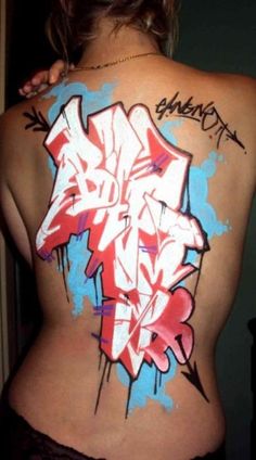 the back of a woman's body with graffiti on it