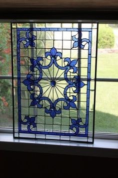 a stained glass window with blue flowers on it