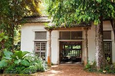 the entrance to an old building with lots of trees