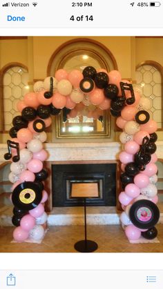 an arch made out of balloons and music notes