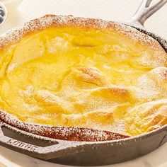 a pie sitting on top of a pan covered in powdered sugar