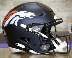 a football helmet sitting on top of a wooden table