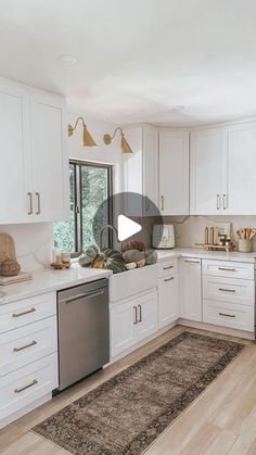 the kitchen is clean and ready to be used for cooking or baking, with all white cabinets and stainless steel appliances