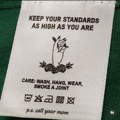 a label on the back of a green jacket that says, keep your standards as high as you are