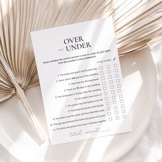 a white plate with a checklist on it next to a book and an umbrella