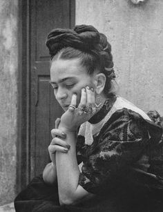 a black and white photo of a woman holding her hands to her face