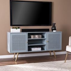 an entertainment center with a flat screen tv mounted on the wall