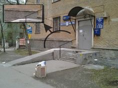 an old building with graffiti on the side and stairs leading up to it's entrance