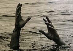 two hands reaching for each other in the water