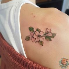 a woman's shoulder with flowers on it