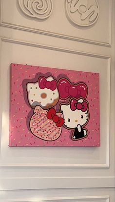 a hello kitty painting hanging on the wall