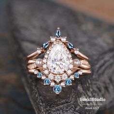 a diamond and blue topaz ring on a rock