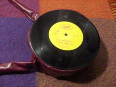 an old record with a purple ribbon on the floor