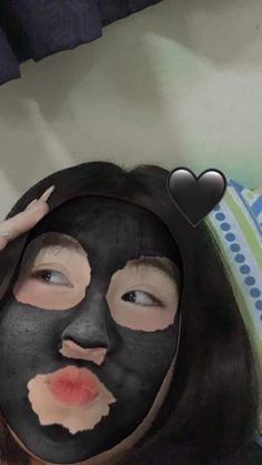 a woman with a black mask covering her face