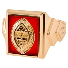 a red and silver ring with a crest on it's side, in front of a white background