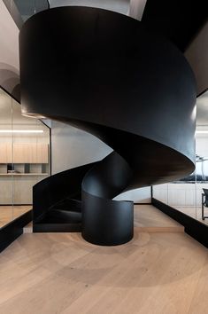 a black spiral staircase in an office building