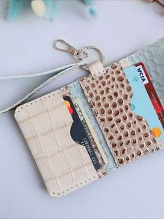 a purse with a card holder attached to it and a keychain hanging from the front