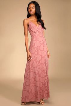 a woman in a pink dress posing for the camera