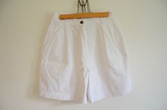 Vintage white cotton high waisted shorts with pockets. It has zip and button closure. Tag:Rafaella CONDITION: in excellent condition.  MEASUREMENTS: waist:32,5 cm hip:52 cm rise:30 cm inseam:15 cm outseam:45 cm With any other questions, please feel free to contact me, all sales are final, I do not accept returns NOTE: I DO NOT SEND ANY ITEMS TO GERMANY! High-waisted White Cotton Bermuda Shorts, White High-waisted Cotton Bermuda Shorts, White High-waisted Bermuda Shorts In Cotton, Vintage High Waist White Shorts, White High Waist Cotton Bermuda Shorts, White High-waisted Shorts With Pockets, White Cotton Bermuda Shorts With Pockets, Vintage White Cotton Shorts, Cute Bathing Suits