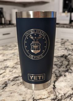 a stainless steel yeti cup sitting on top of a marble counter