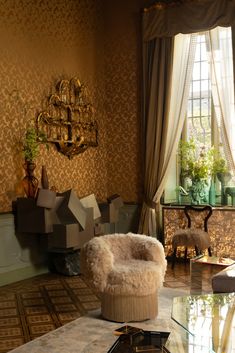 a living room filled with furniture and a glass top table in front of a window