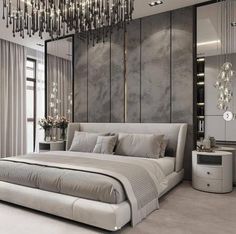 a large bed sitting under a chandelier in a bedroom